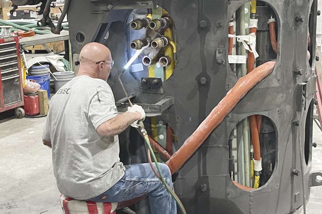 IMG_0969-scaled An employee conducting an induction furnace repair at EMSCO, a foundry service provider.